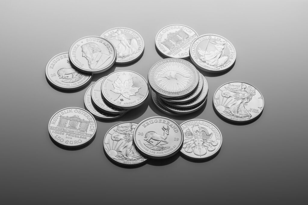 silver round coins on white surface